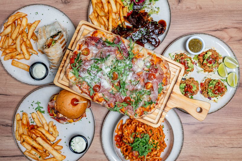 Full punch pizza spread with multiple dishes on the table